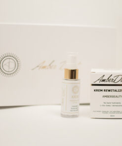Kosmetyki z bursztynem AmberDust: krem rewitalizujący i krem regenerujący do rąk w eleganckich opakowaniach na białym tle